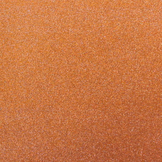 A close-up image of orange glitter cardstock with a non-shedding characteristic, showing the texture and glitter finish.