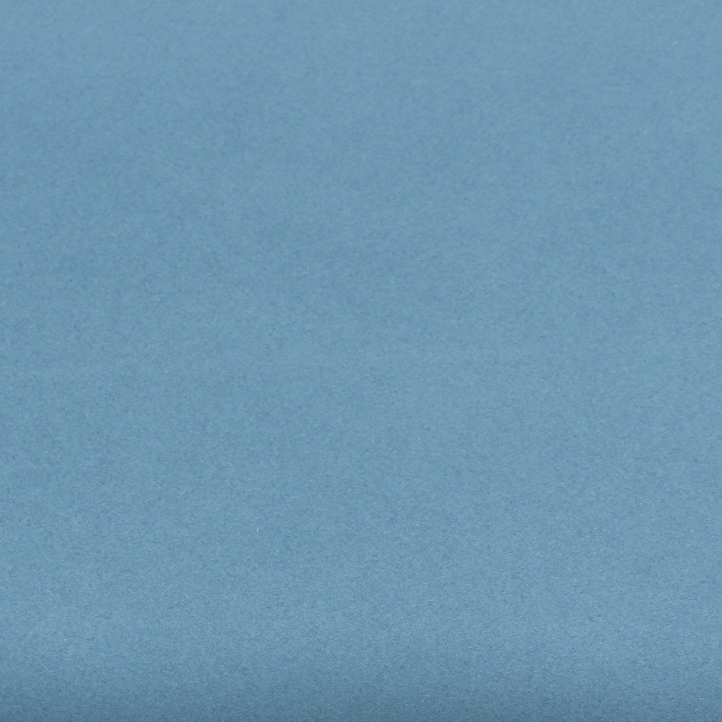A single sheet of dusty blue cardstock paper with a smooth finish.