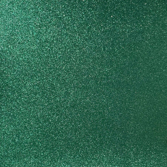A close-up image of green glitter cardstock with a focus on its textured surface covered in glitter.