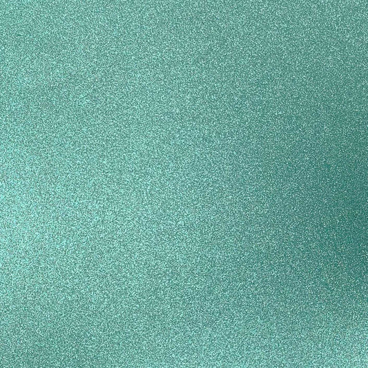A close-up image of mint green glitter cardstock with a shimmering finish.