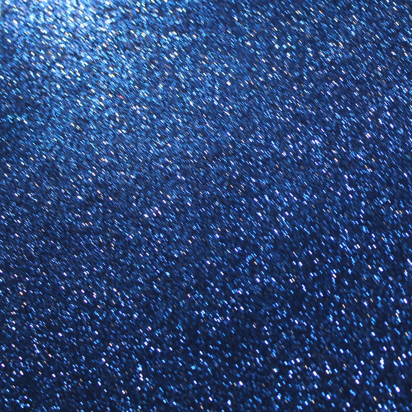 A close-up image of navy blue glitter cardstock showing the texture and glitter detail.