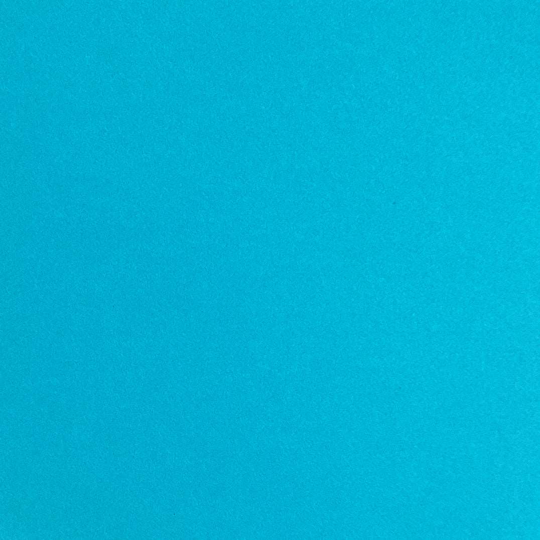 A single sheet of teal blue cardstock paper with a smooth finish.
