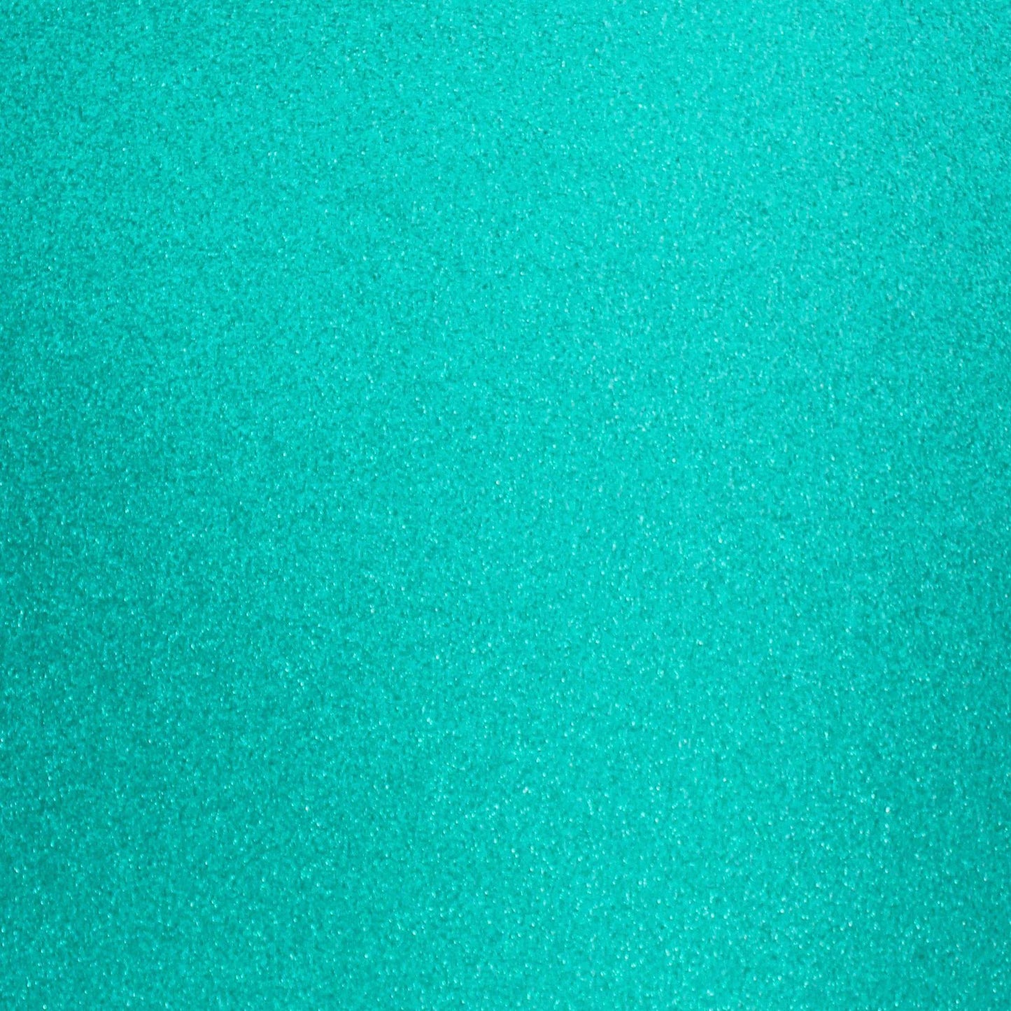 A close-up image of turquoise blue glitter cardstock with a shimmering texture.