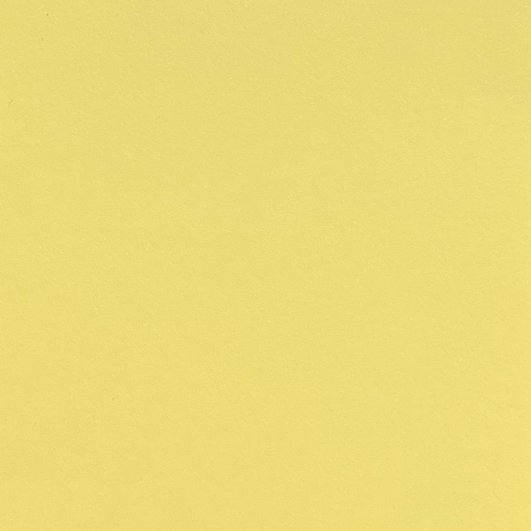 A single sheet of light yellow cardstock paper with a smooth finish.