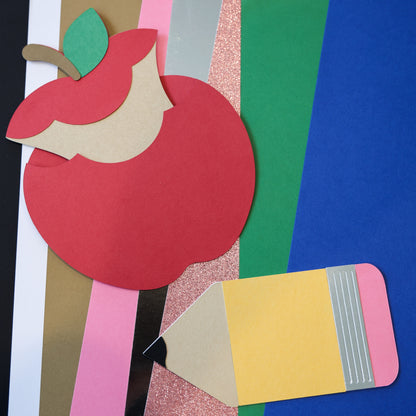 Apple and pencil gift card holders cut from cardstock on colorful paper background