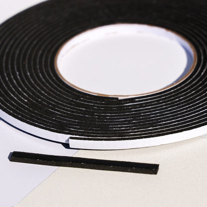 Black double sided 3D foam tape roll with a cut strip for layered cardstock and card making