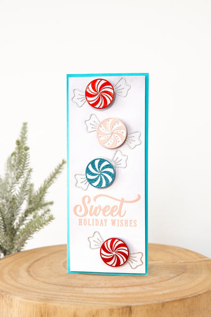Sweet Holiday Wishes peppermint spinner card with red mirror, light pink, and light blue glitter candies, silver glitter wrappers, on a powder blue card base