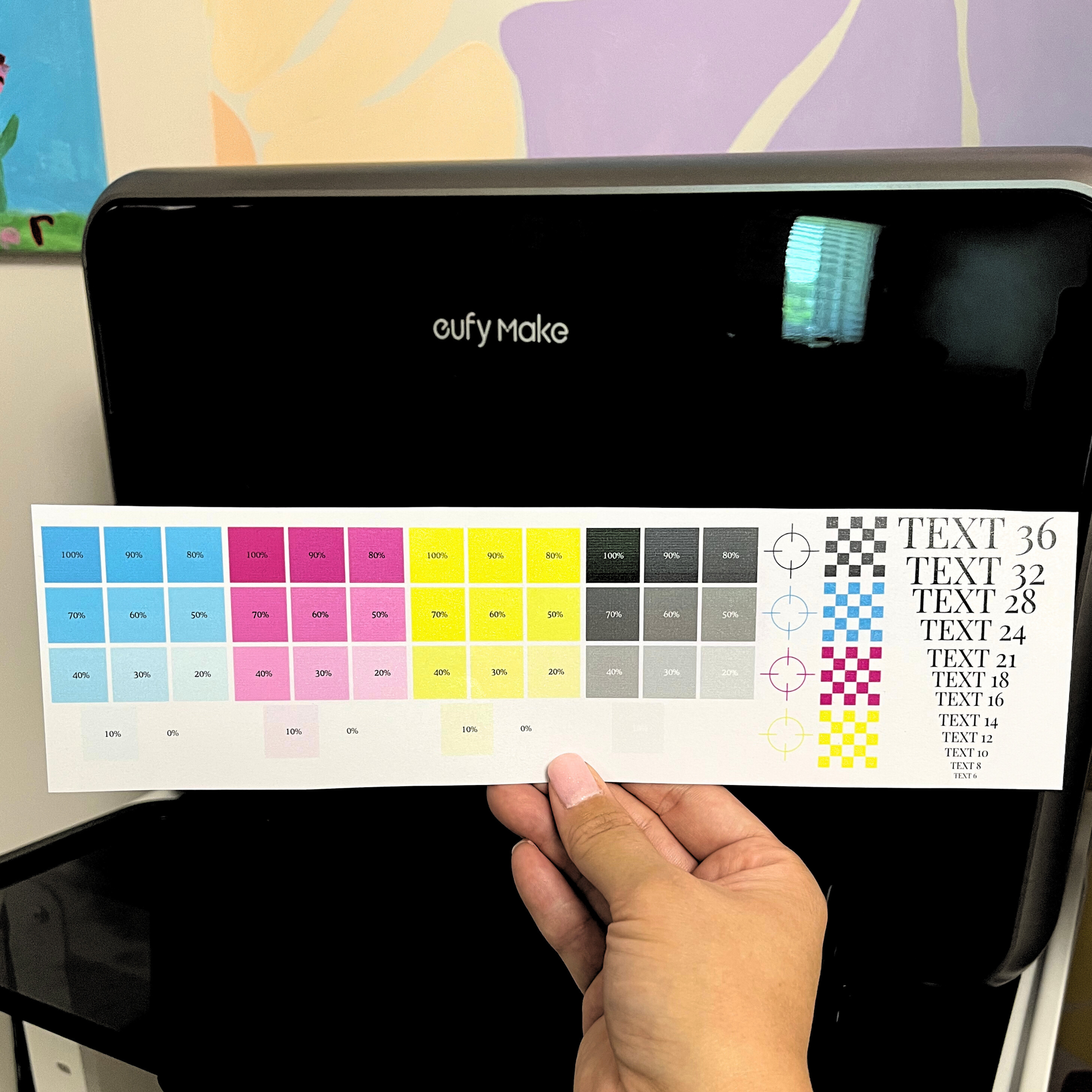 eufy Make uv printer with a color swatch held in front of it