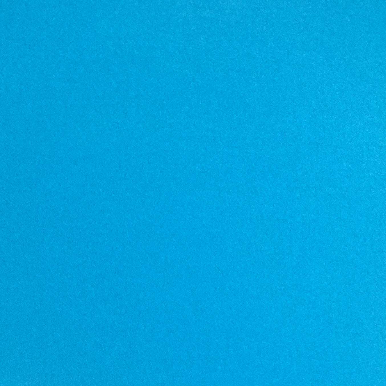A single sheet of cyan blue cardstock paper with a smooth finish.