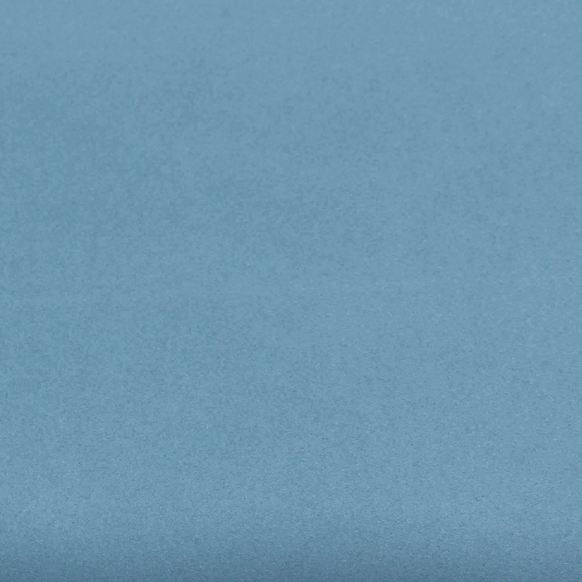 A single sheet of dusty blue cardstock paper with a smooth finish.