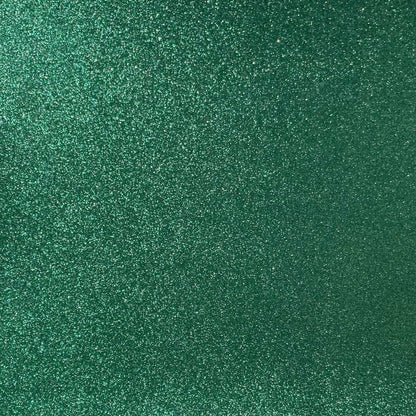 A close-up image of green glitter cardstock with a focus on its textured surface covered in glitter.