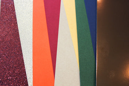 Close-up of shed-free dark red wine and champagne glitter cardstock in the fall variety pack
