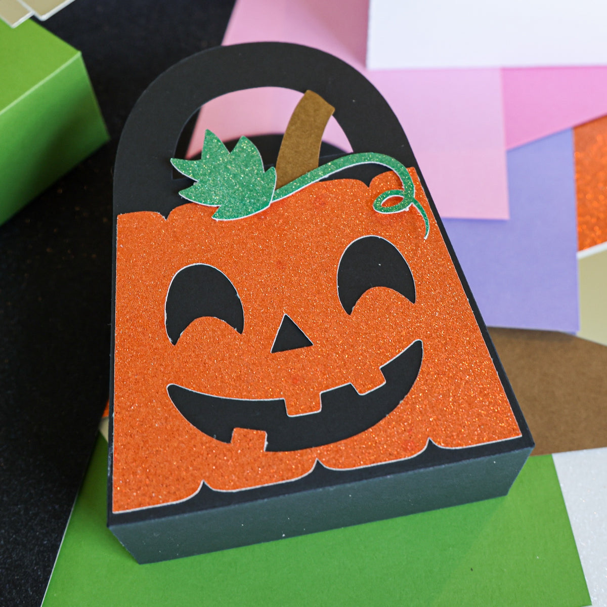 Close up of the jack-o-lantern boo bag cut from orange glitter and black cardstock