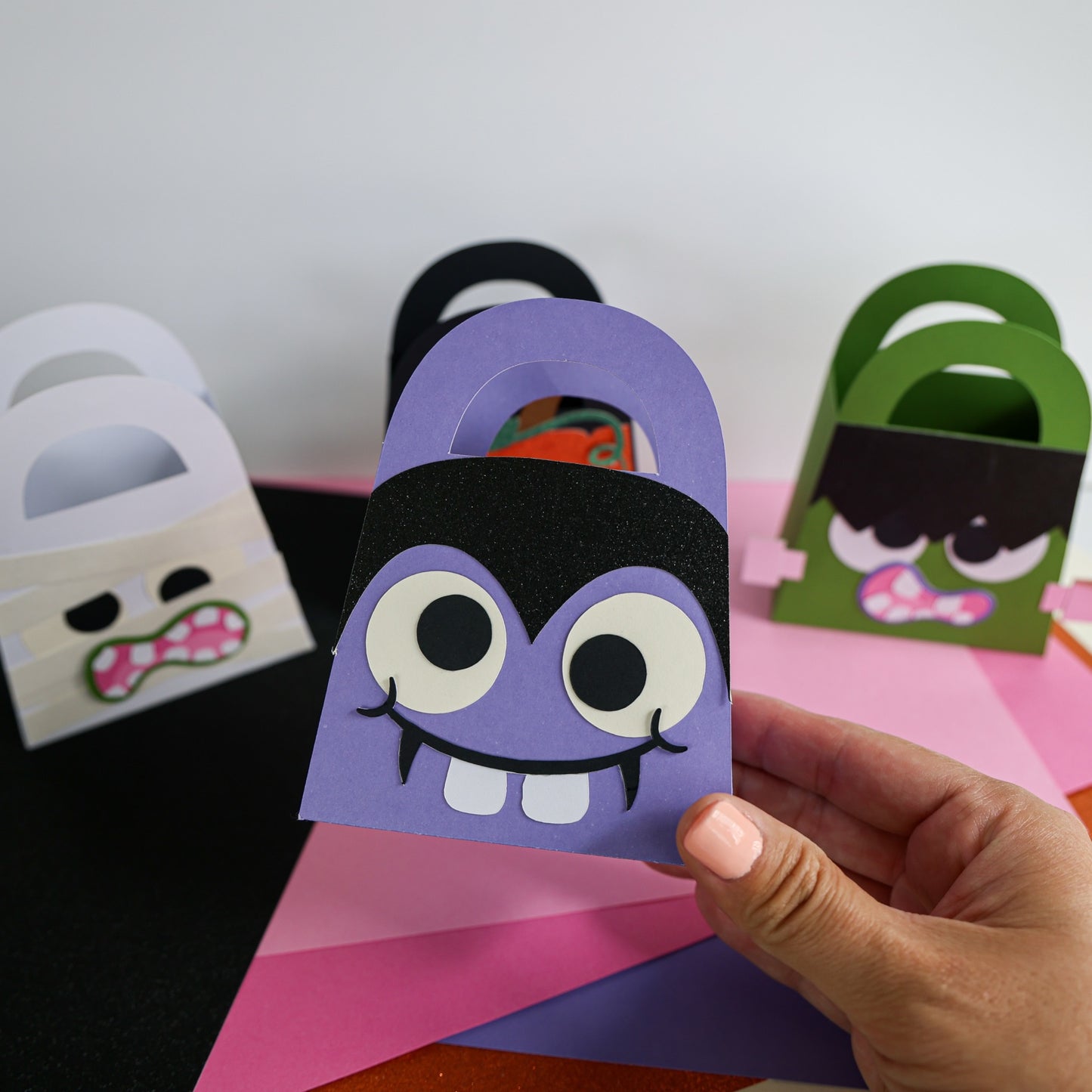 Purple vampire boo bag held in hand showing the finished Halloween treat bag size