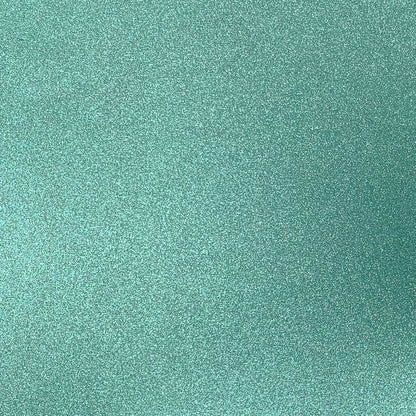 A close-up image of mint green glitter cardstock with a shimmering finish.