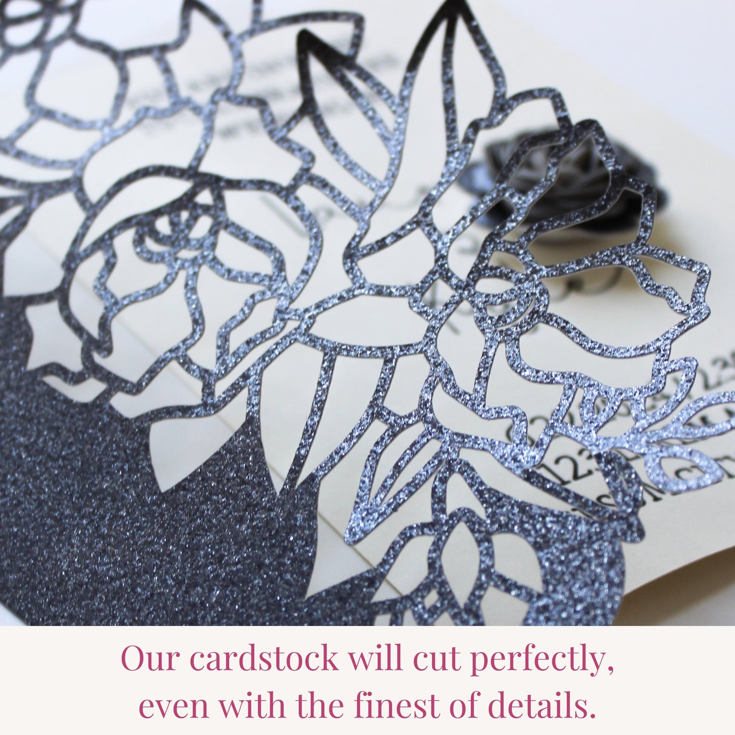 Moonlight black glitter cardstock cut with intricate floral detail on a laser cut wedding invitation