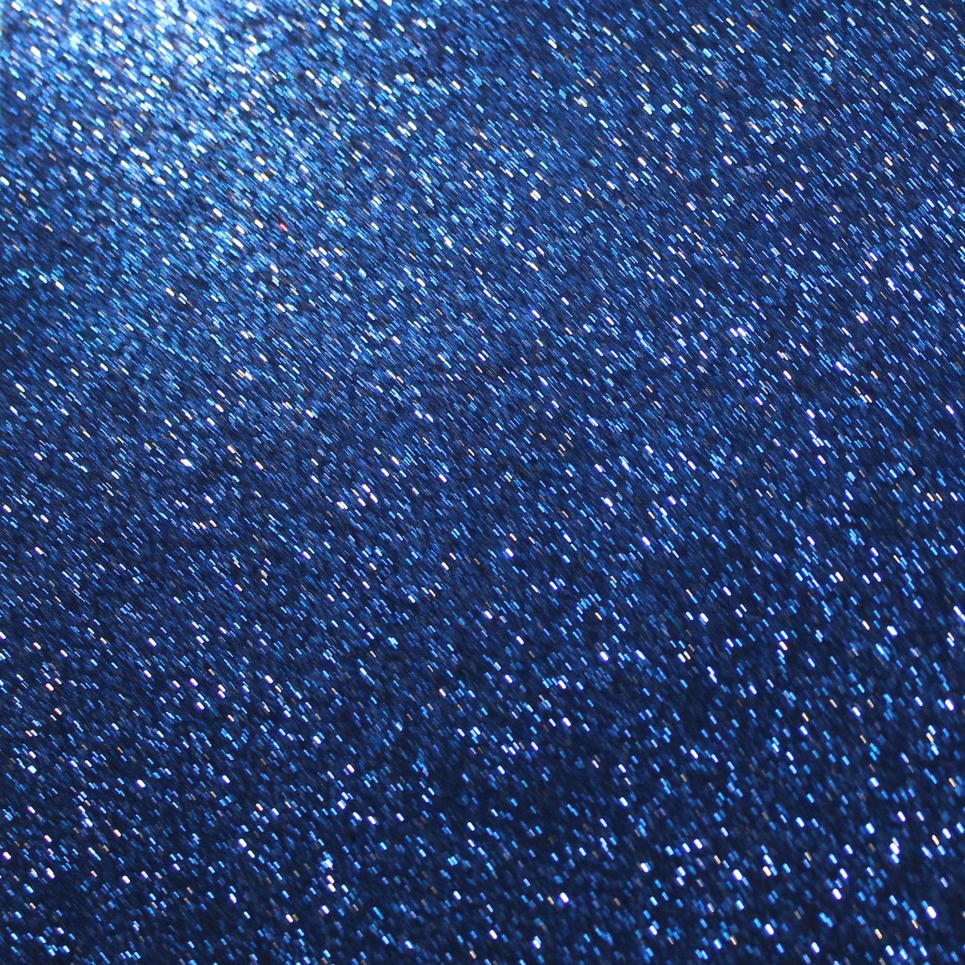 A close-up image of navy blue glitter cardstock showing the texture and glitter detail.