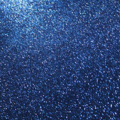 A close-up image of navy blue glitter cardstock showing the texture and glitter detail.