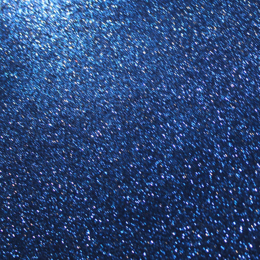 A close-up image of navy blue glitter cardstock showing the texture and glitter detail.