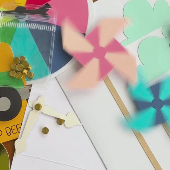 Video of gold cardstock spinners making paper pinwheels and cardstock clock hands spin on handmade cards