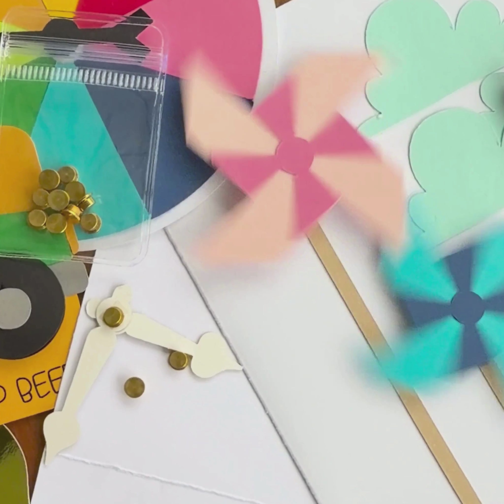 Video of gold cardstock spinners making paper pinwheels and cardstock clock hands spin on handmade cards