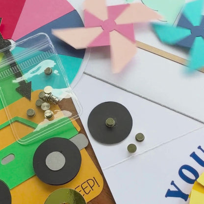 Video of silver cardstock spinners making paper pinwheels and a black cardstock wheel spin on handmade cards