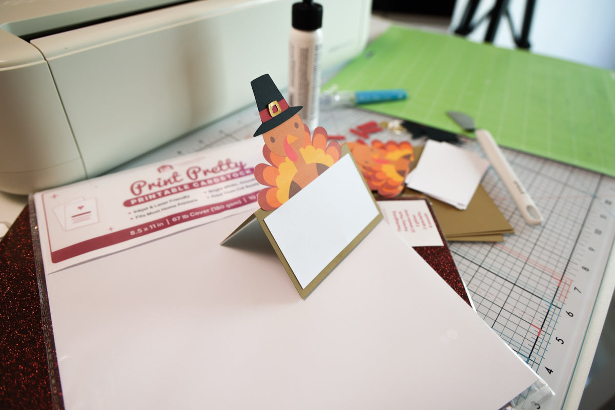 Finished turkey place card made from the turkey place card SVG, standing on a craft table