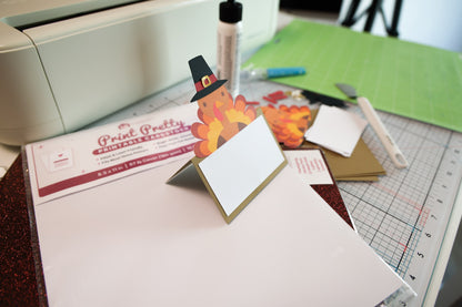 Finished turkey place card made from the turkey place card SVG, standing on a craft table