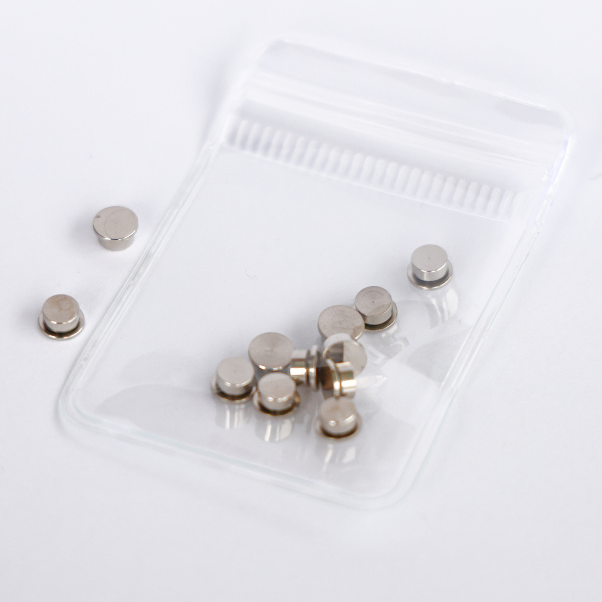 10 pack of silver metal cardstock spinners with a built-in bearing in a clear resealable bag, 5mm top and 4mm base