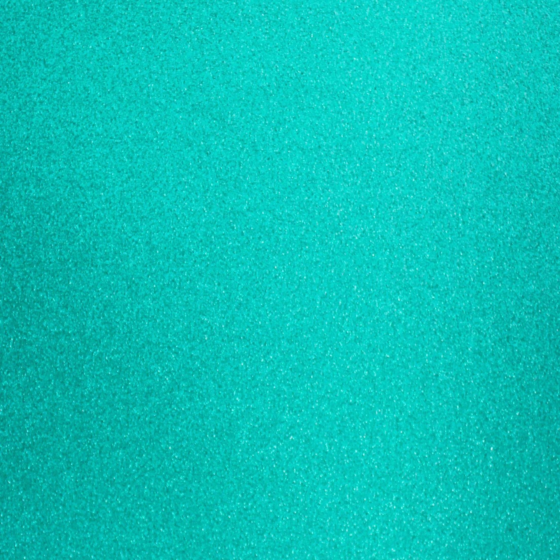 A close-up image of turquoise blue glitter cardstock with a shimmering texture.