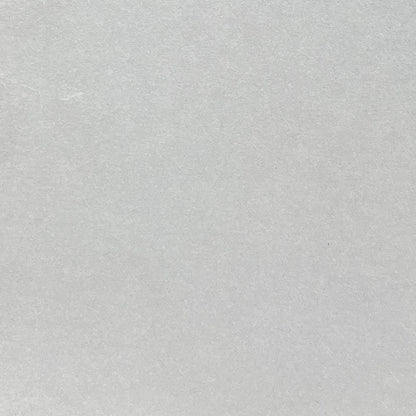 Close-up of light grey cardstock with a matte smooth finish
