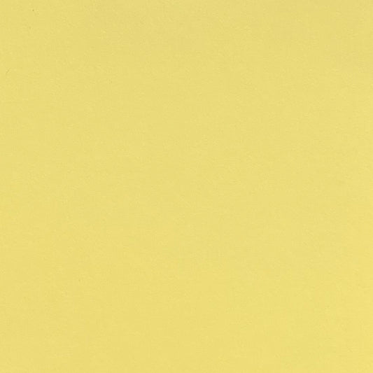A single sheet of light yellow cardstock paper with a smooth finish.